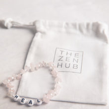 Load image into Gallery viewer, heal crystal healing bracelet in rose quartz position against white THE ZEN HUB bag