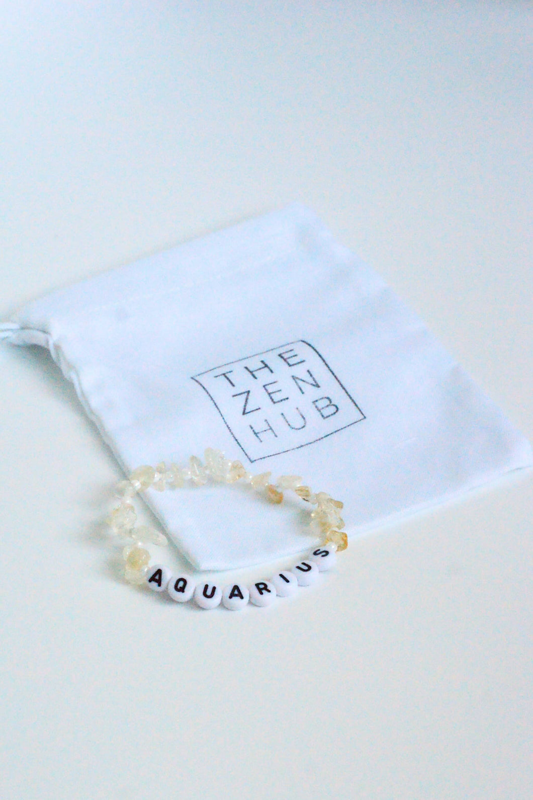 Aquarius crystal healing gemstone bracelet made from citrine on white cotton bag