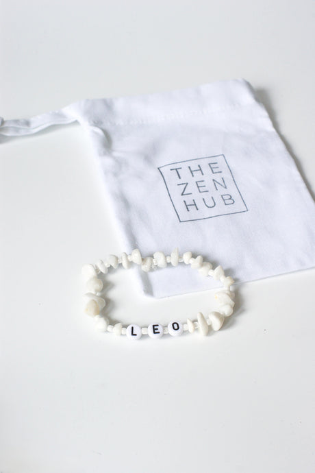 Leo Star Sign Crystal bracelet on white cotton bag on white surface