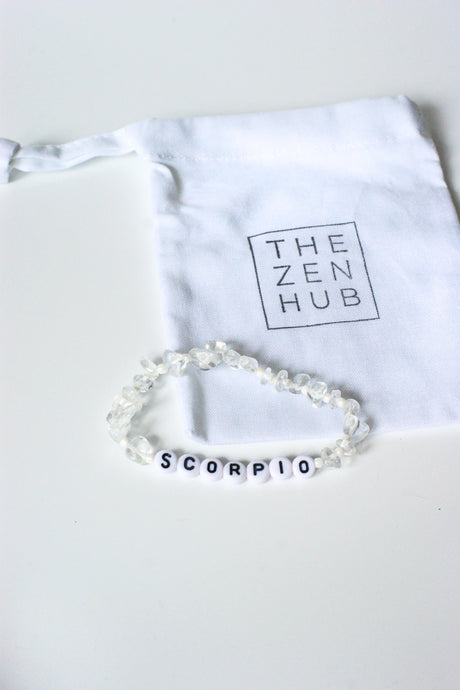 Scorpio crystal bracelet made from clear quartz on white cotton bag