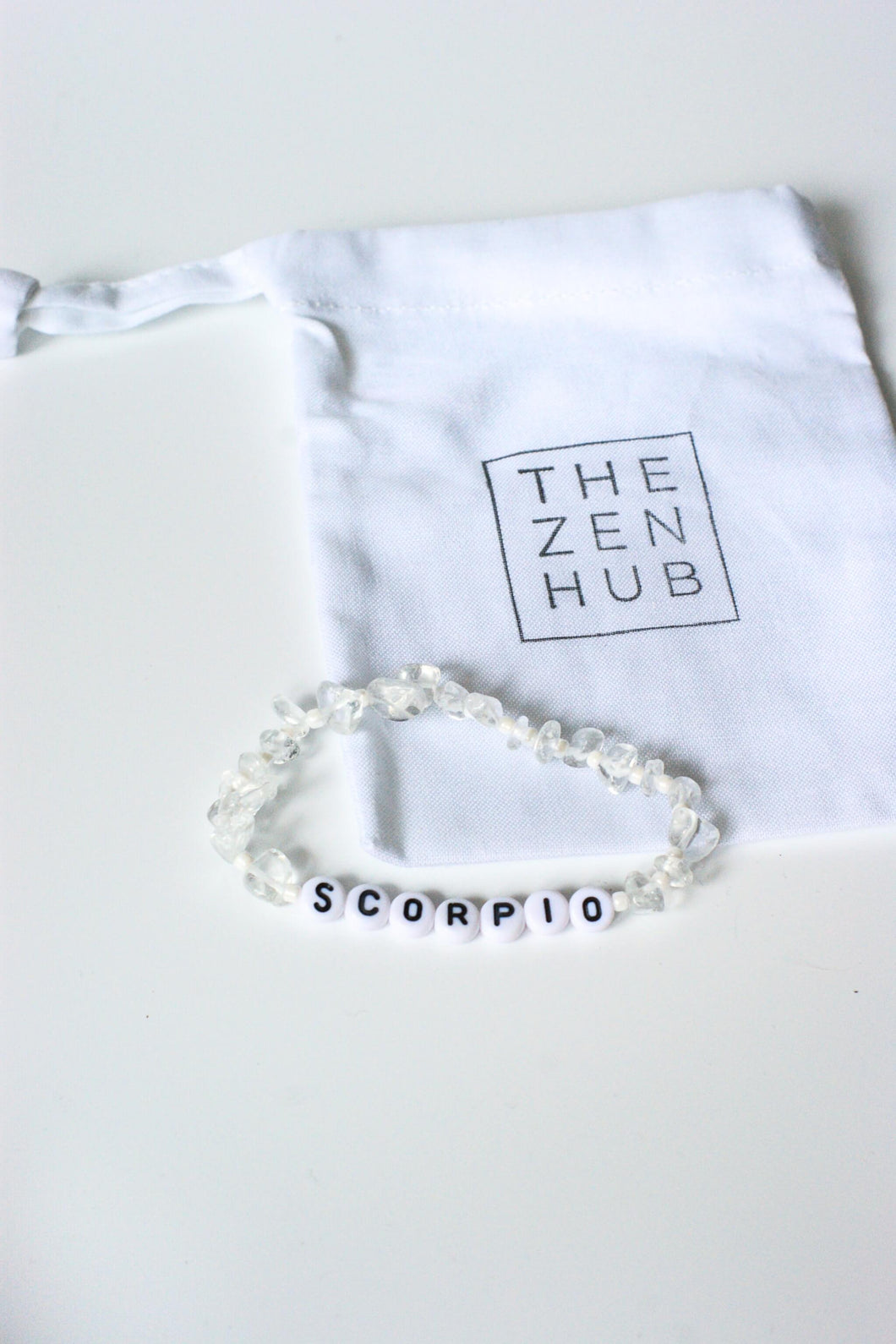 Scorpio crystal bracelet made from clear quartz on white cotton bag