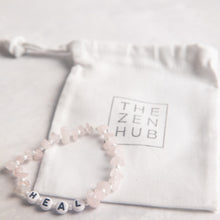 Load image into Gallery viewer, heal crystal healing bracelet in rose quartz position against white THE ZEN HUB bag
