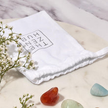 Load image into Gallery viewer, a white cotton bag with the zen hub logo on displayed in white marble background
