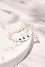 Load image into Gallery viewer, rose quartz heal crystal bracelet displayed on white marble background 
