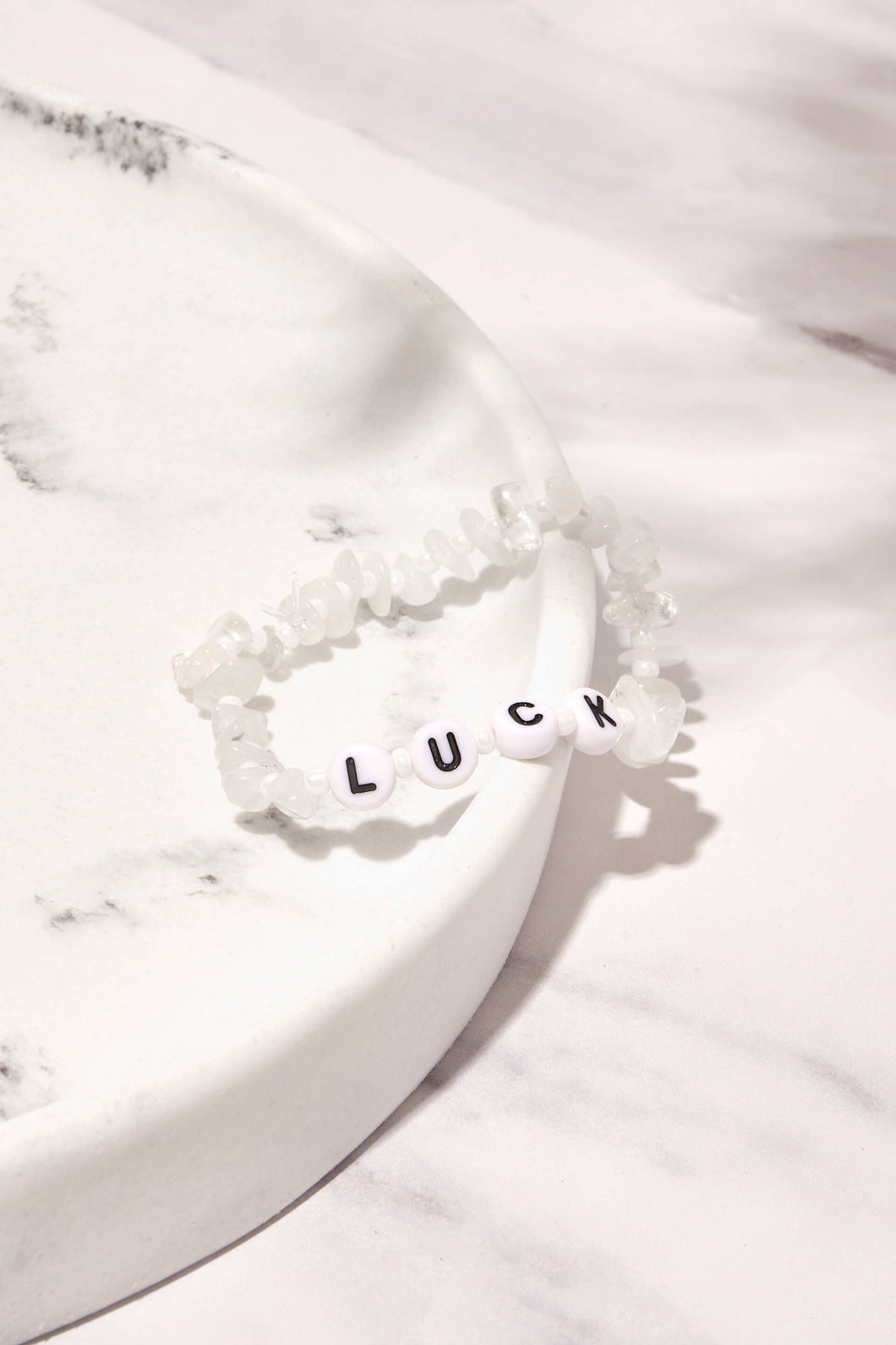 Lucky moonstone bracelet presented on white marble background