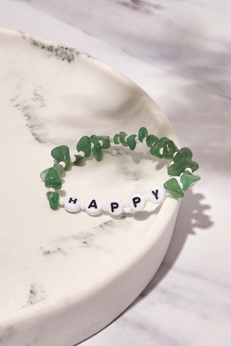 happy bracelets on white marble background